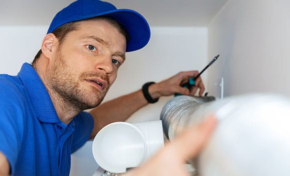 mike on the job - wellington fitting airconditioning pipes